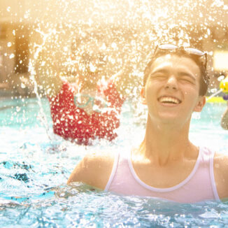 Group of young adults having fun in the pool