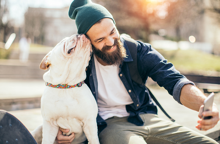 Young man taking a selfie with his dog